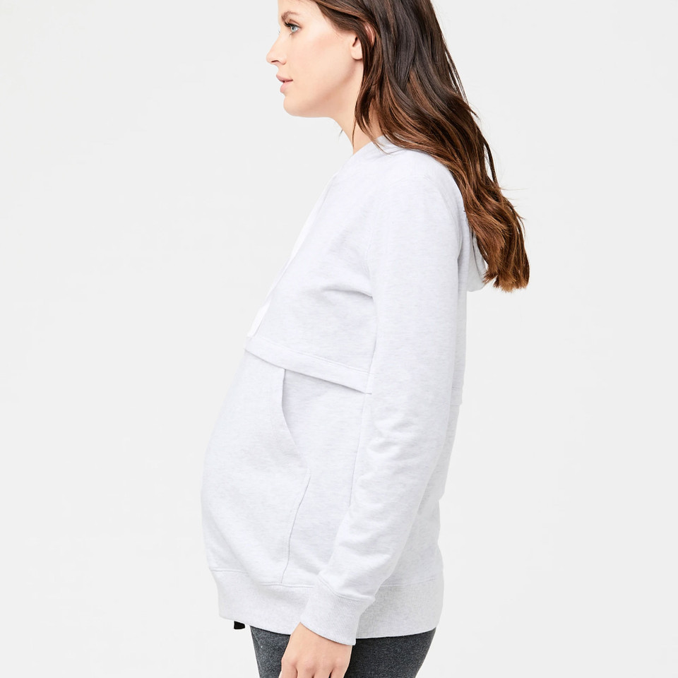 Model in profile wearing a white marle maternity hoodie with layered nursing panel and ribbed cuffs