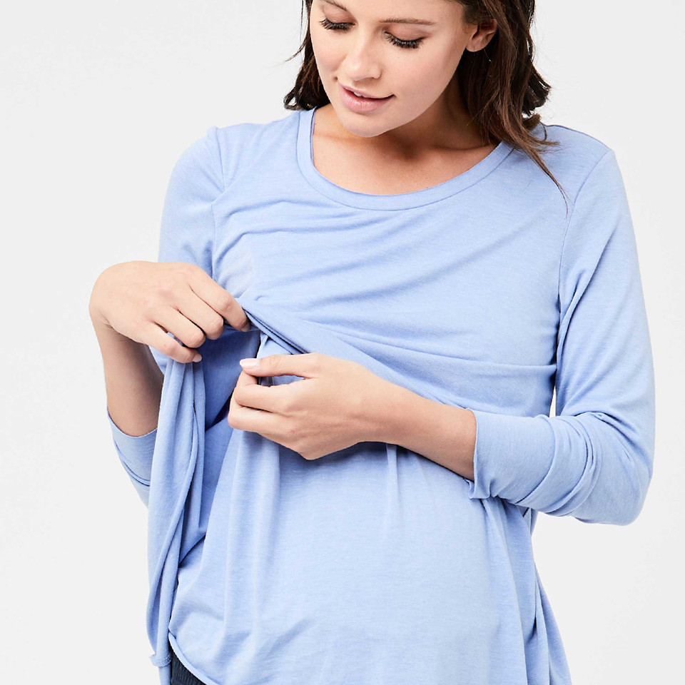 Model demonstrating nursing access panel on a sky blue marle long sleeve maternity top with round neckline