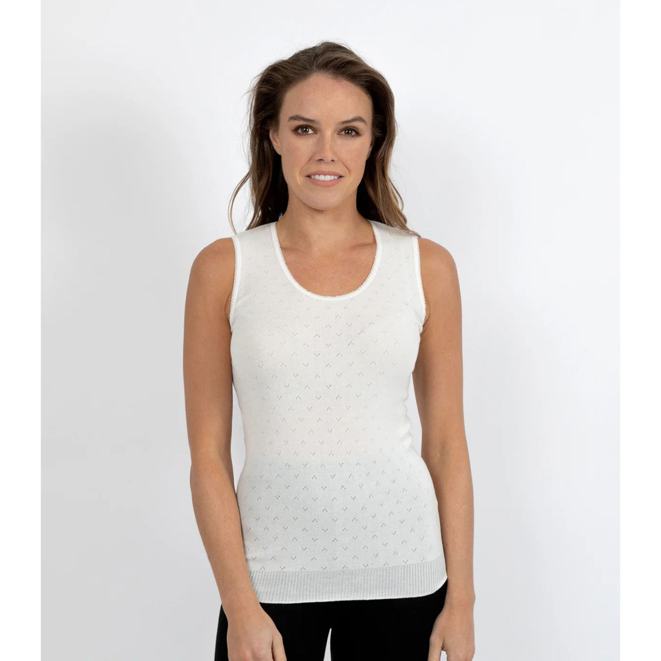 White sleeveless thermal vest with textured waffle knit fabric and ribbed hemline on female model