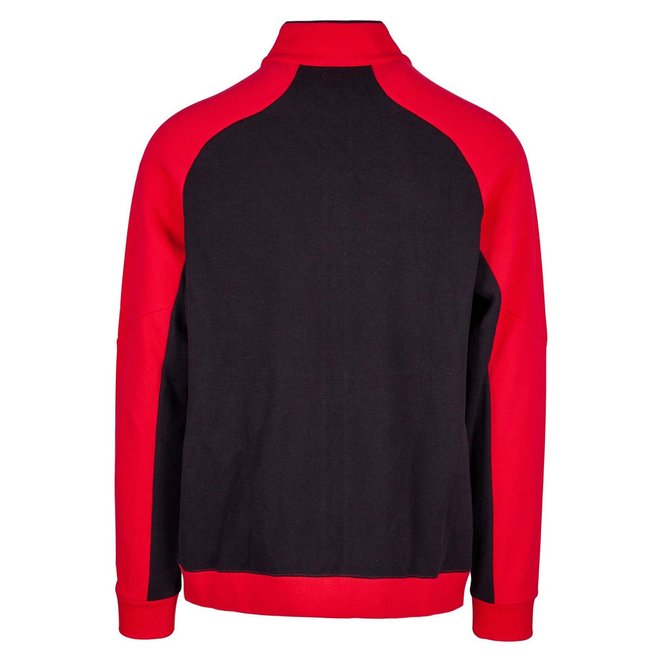 Black jacket with red contrast raglan sleeves and high neck collar, back view