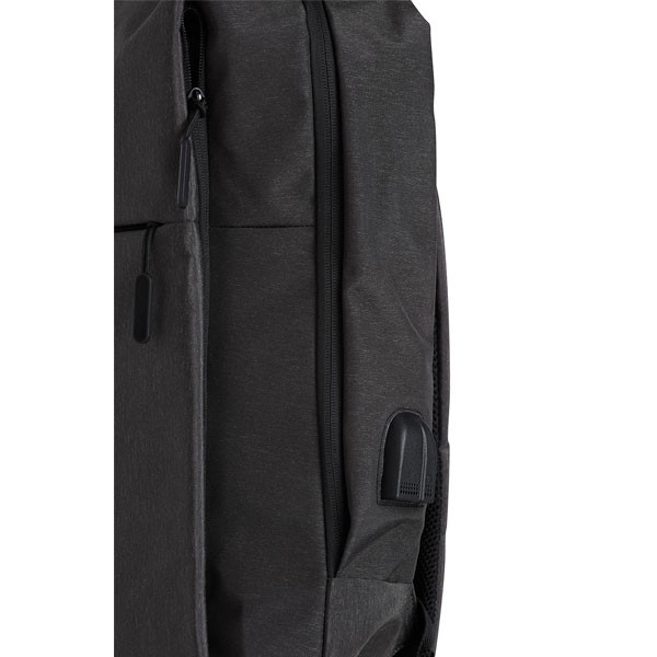 Close-up of charcoal heather backpack showing zip pocket, padded strap and USB port detail