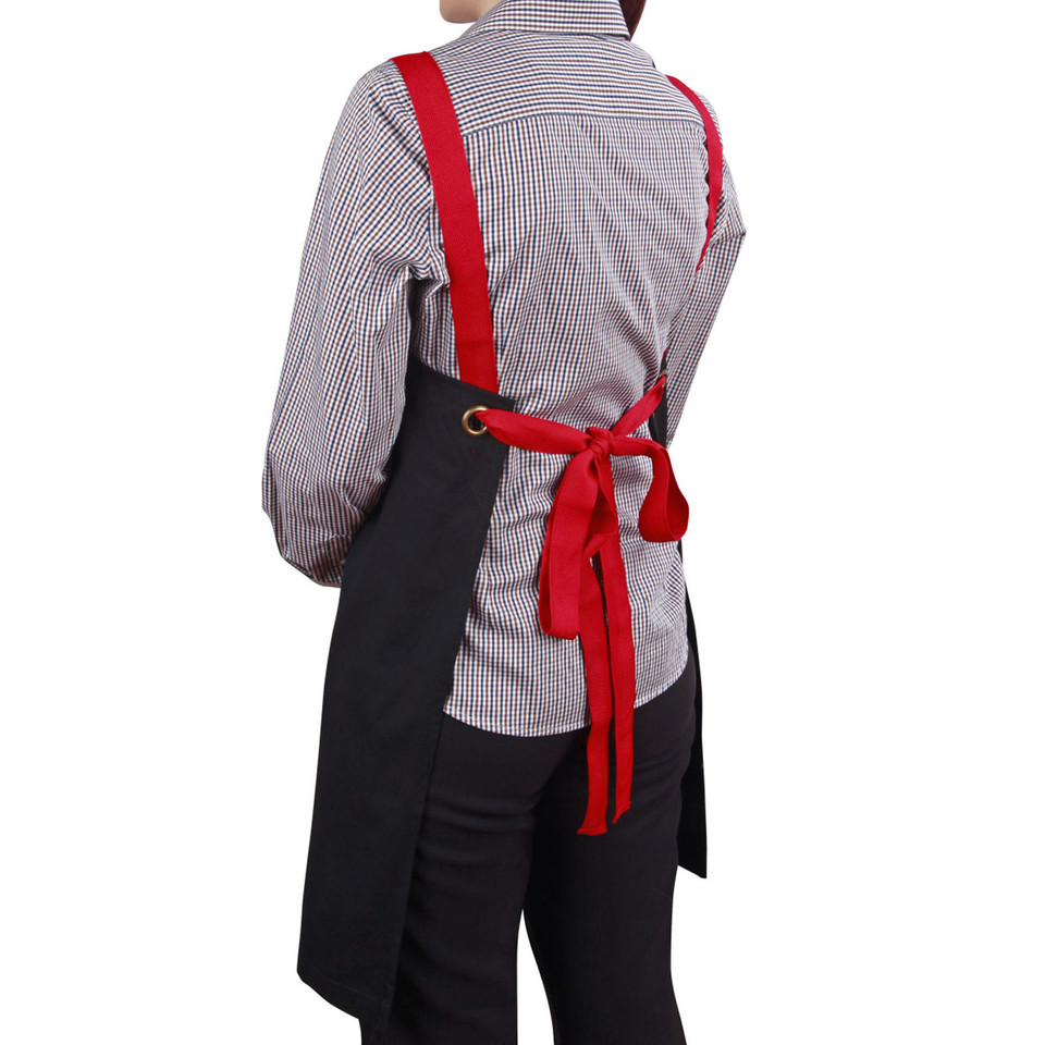 Black cotton canvas bib apron with bright red adjustable straps and ties, worn over checkered shirt