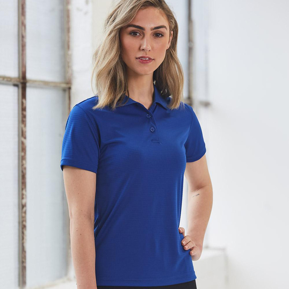 Woman wearing royal blue short-sleeve polo with subtle self-stripe texture and three-button placket