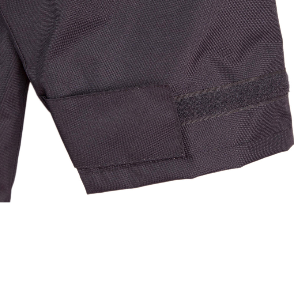 Charcoal grey jacket sleeve cuff with velcro adjustment tab and reinforced stitching detail