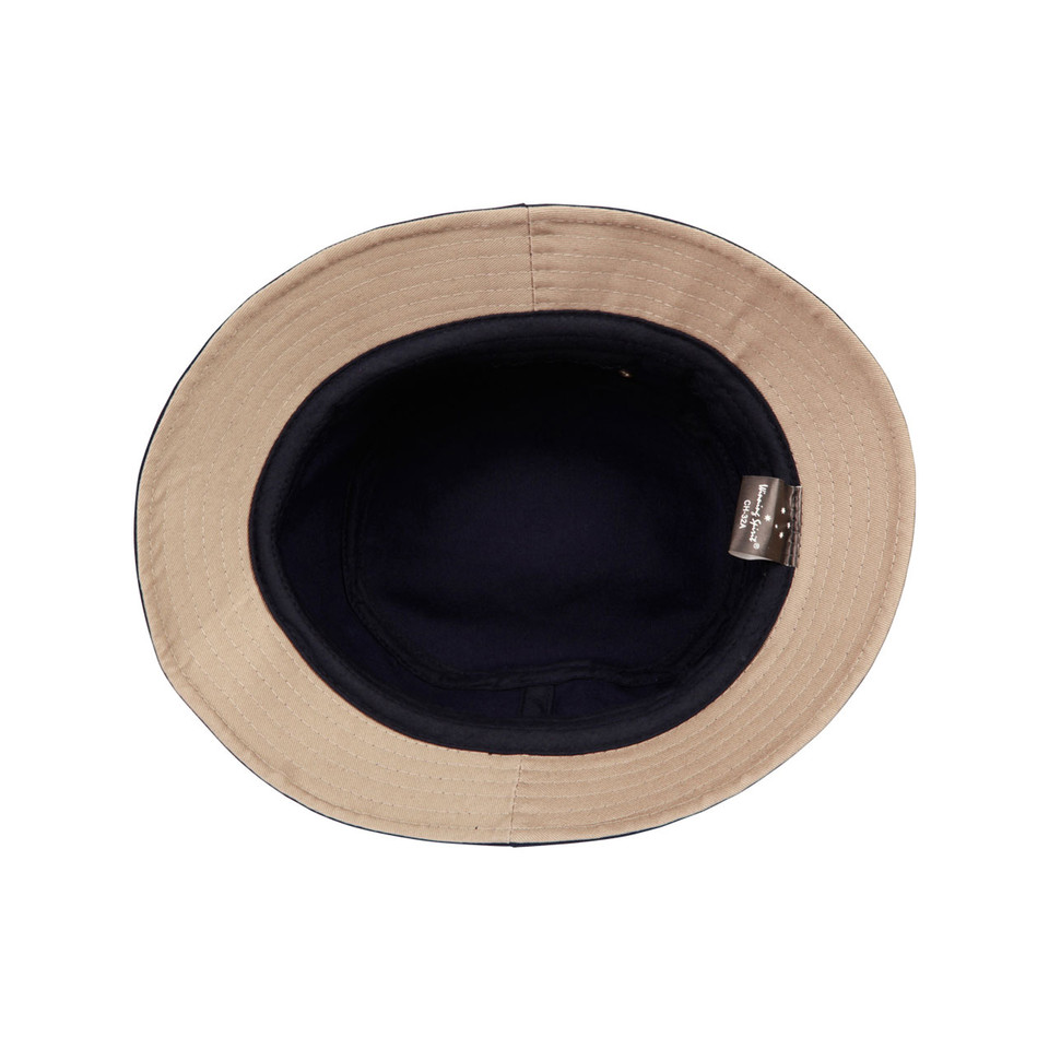 Beige cotton bucket hat with contrasting navy inner crown and brim lining viewed from above