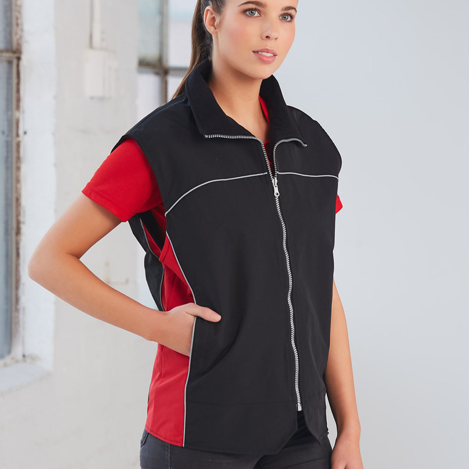 Woman wearing black full-zip vest with red contrast panels and white reflective piping, zip pockets