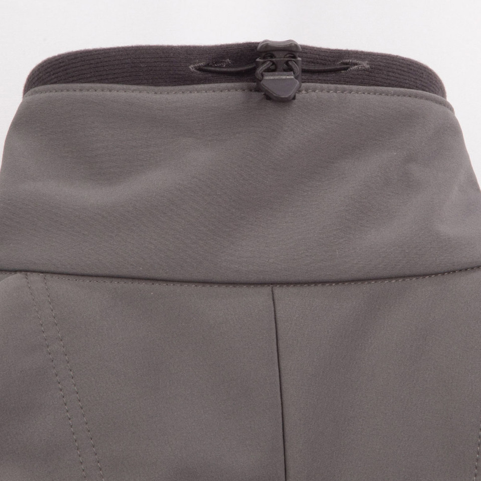 Charcoal grey softshell jacket showing back waistband with black zip pocket detail and contrast stitching