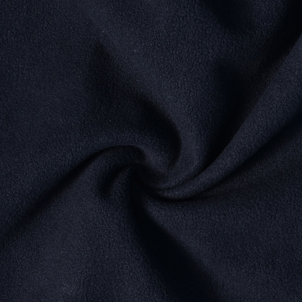 Close-up of navy blue softshell fleece fabric showing soft texture and draped folds