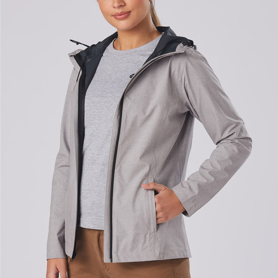 Woman wearing open silver-grey waterproof jacket with black contrast hood and zip side pockets