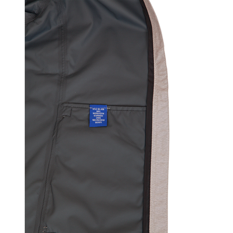 Interior lining detail of charcoal performance jacket showing mesh fabric, chest pocket and stone contrast side panel