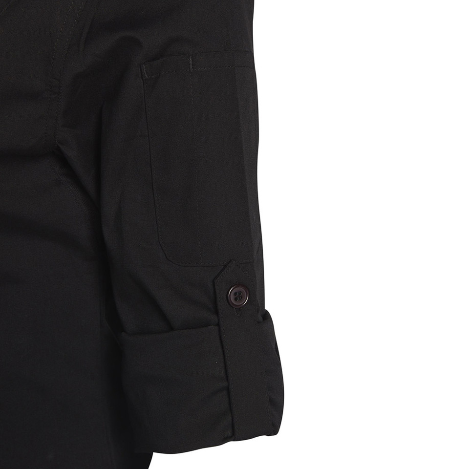 Black ladies chef jacket detail showing chest pocket, rolled cuff and dark button fastening