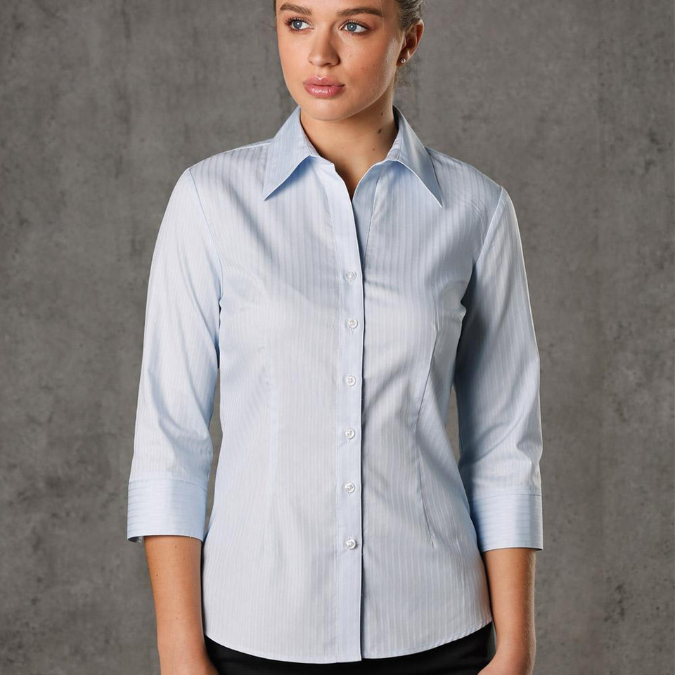 Woman wearing pale blue self-stripe button-up shirt with point collar and 3/4 sleeves