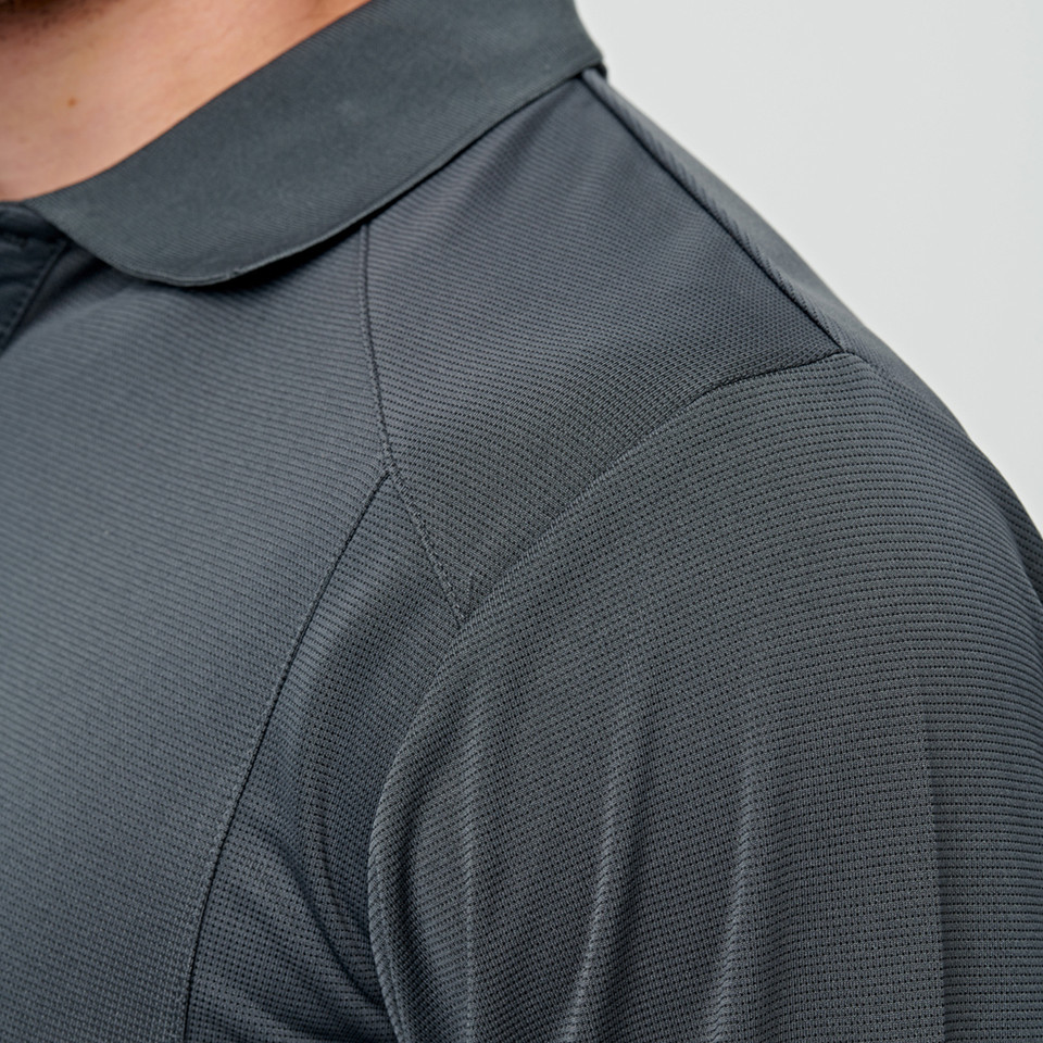 Charcoal grey bamboo polo shirt showing textured fabric, flat collar and shoulder panel seam detail