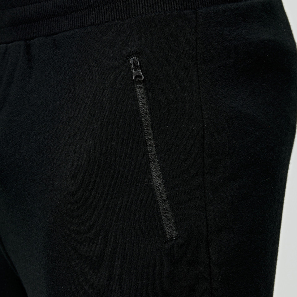 Black French terry jogger pants with zippered side pocket and ribbed waistband detail