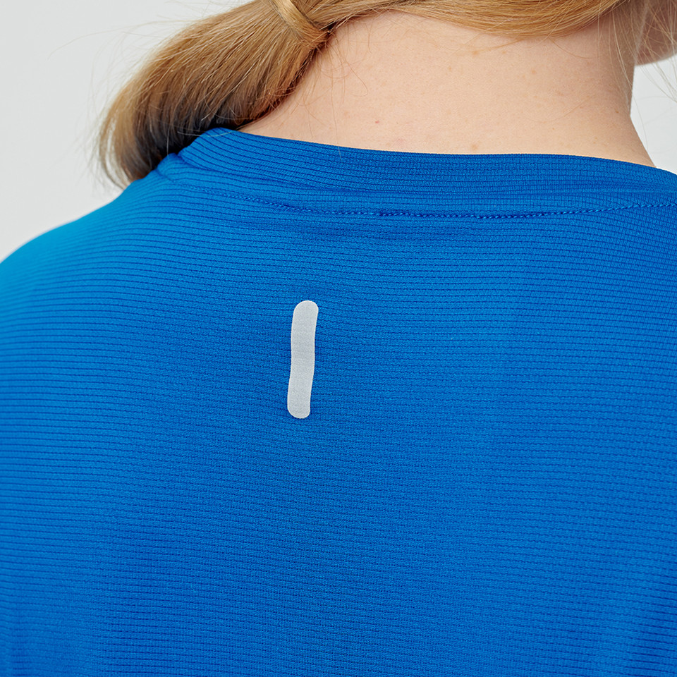 Royal blue performance tee with textured fabric and reflective back tab detail