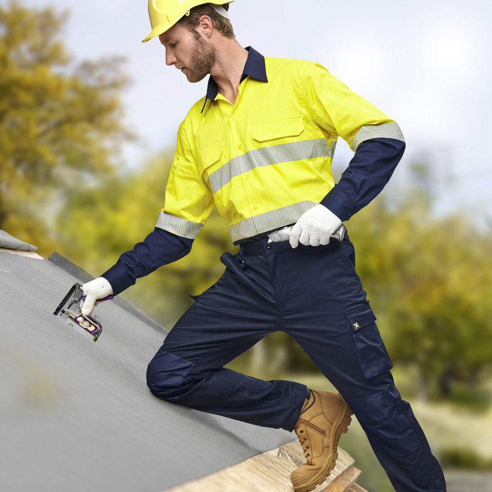 Navy utility cargo pants with multiple pockets and reinforced knee panels shown in workwear setting
