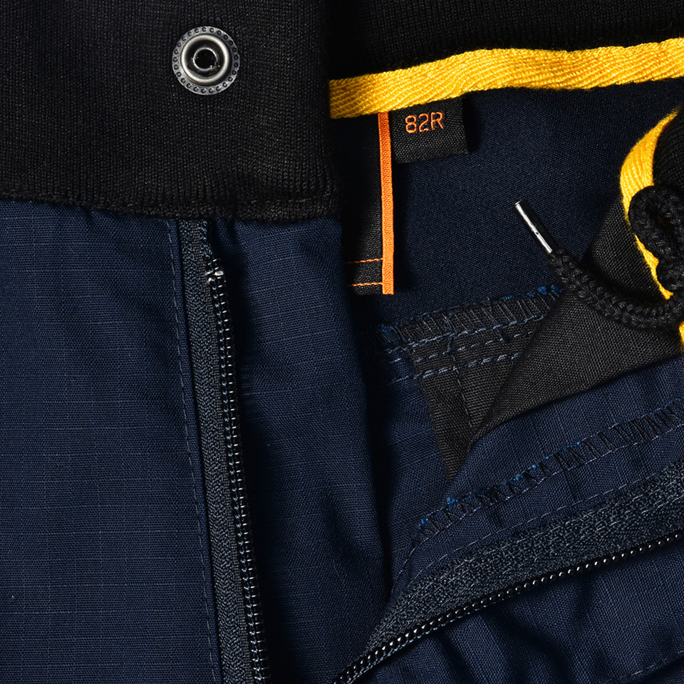 Navy rip-stop work shorts with contrast golden yellow pocket trim and black mesh lining detail