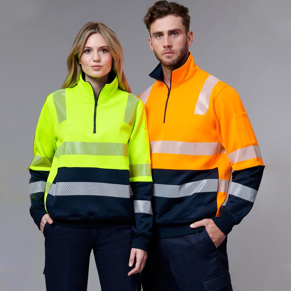 Hi-vis yellow and orange safety jumpers with reflective tape, navy contrast panels, and half zippers