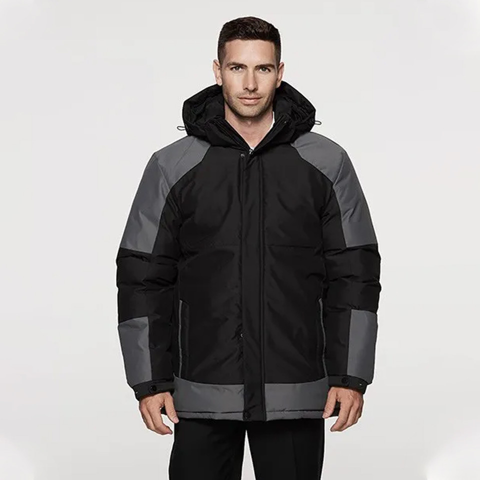 Man wearing black and charcoal grey heavy padded waterproof jacket with hood, contrast panel shoulders and chest zip