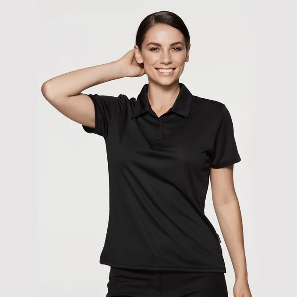 Woman wearing a black short-sleeve polo shirt with three-button placket and textured mini waffle knit fabric