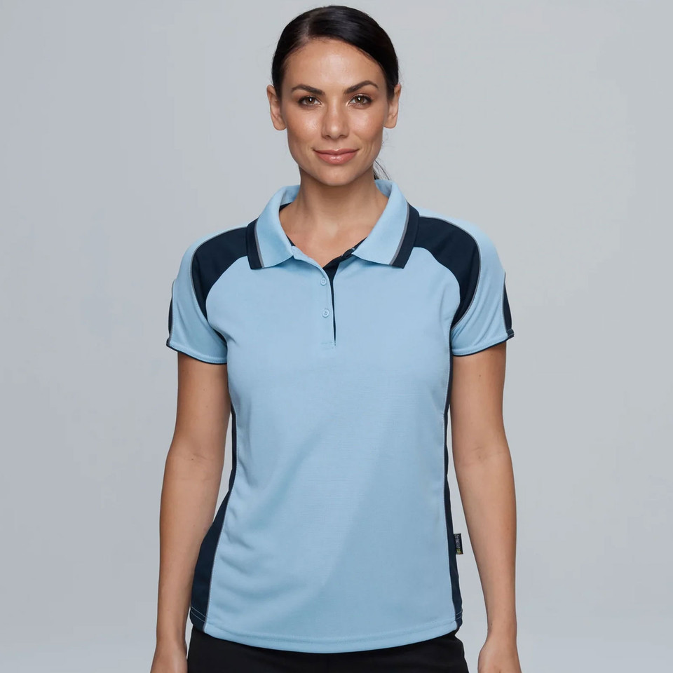 Woman wearing sky blue and navy contrast panel short sleeve polo with ribbed collar and three-button placket