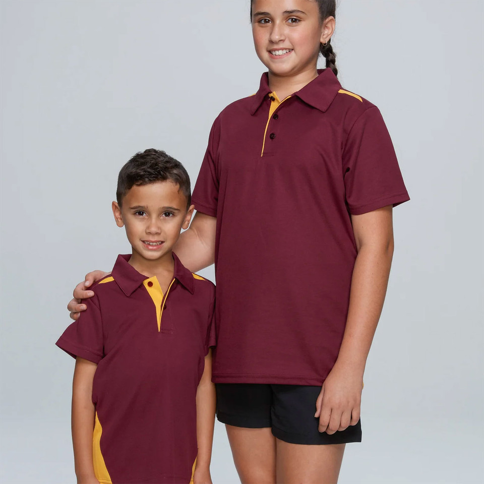 Two children wearing maroon and gold contrast panel polo shirts with button placket and shoulder inserts