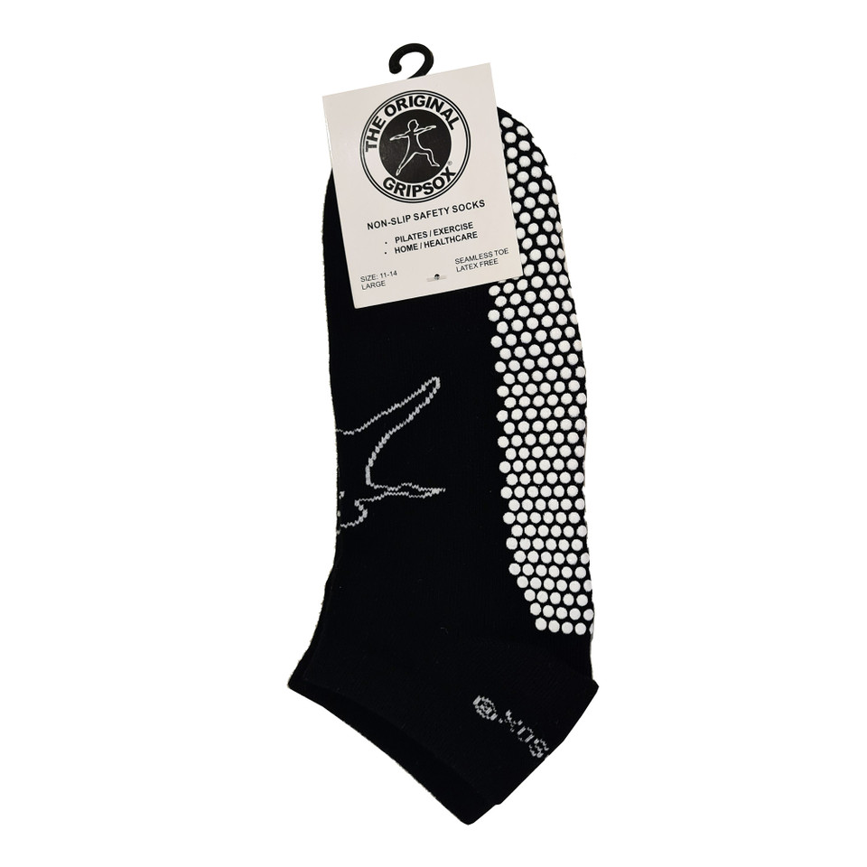Black ankle grip socks with white non-slip dots on sole and silver logo detail