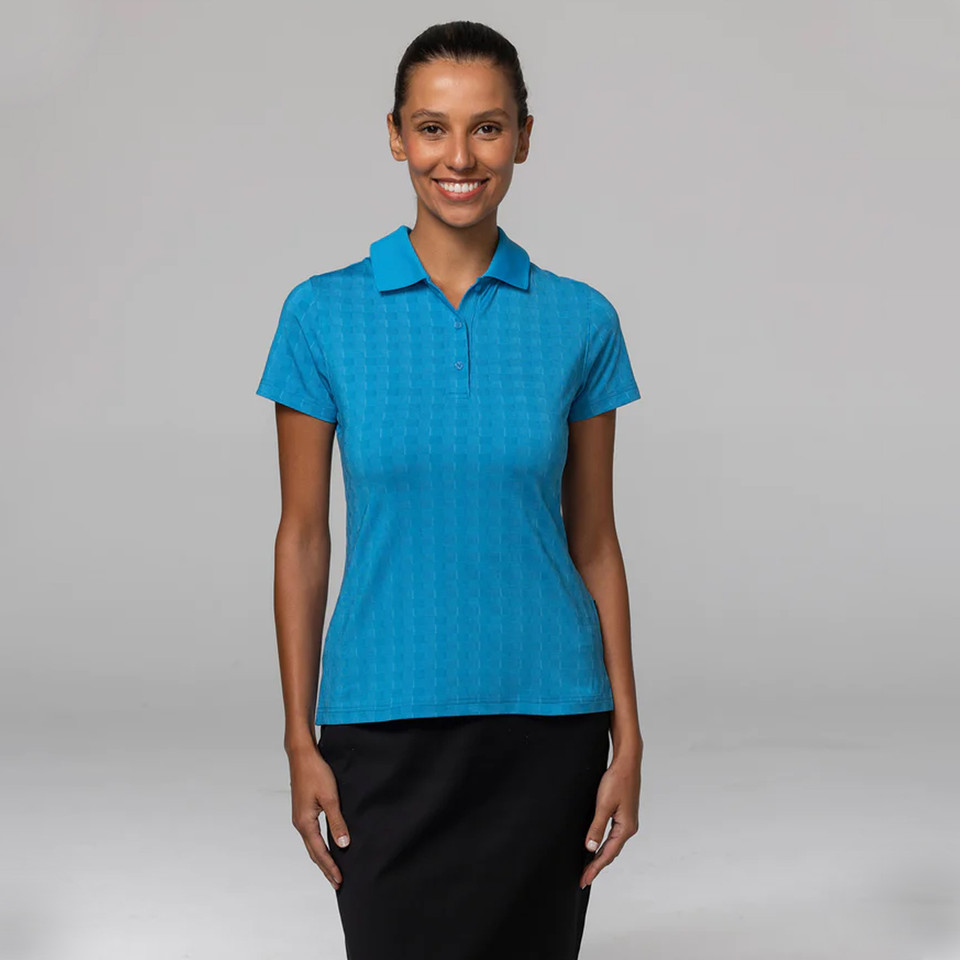 Woman wearing a cyan blue ladies polo shirt with subtle tone-on-tone diamond jacquard texture and flat collar