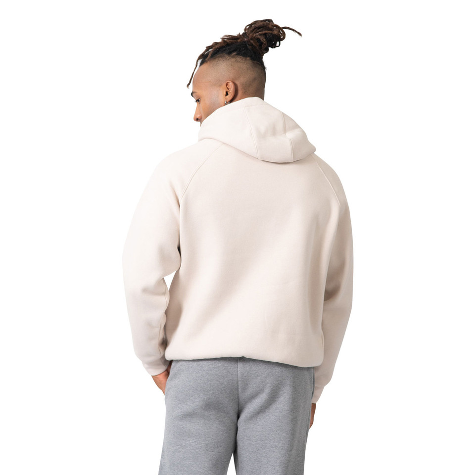 Rear view of pale pink oversized hoodie with grey sweatpants showing relaxed fit and dropped shoulders