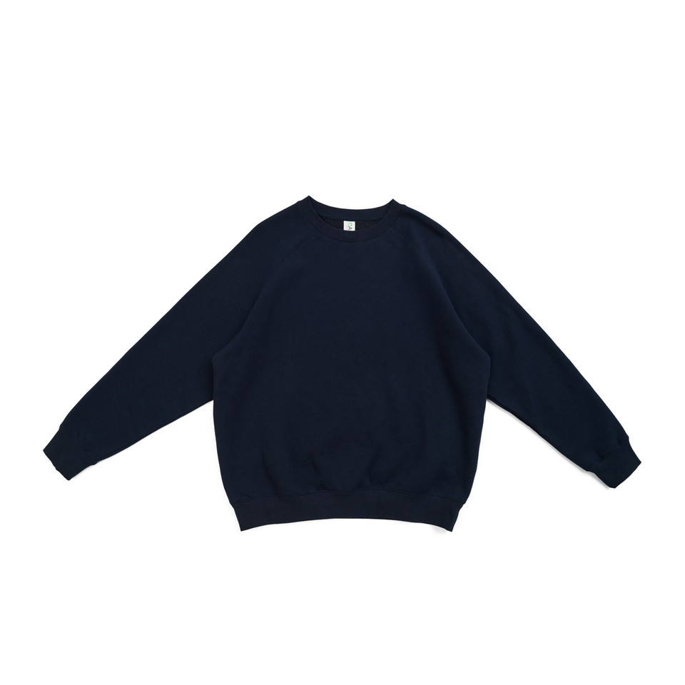 Navy crew neck fleece sweater with ribbed cuffs and hem laid flat on white background