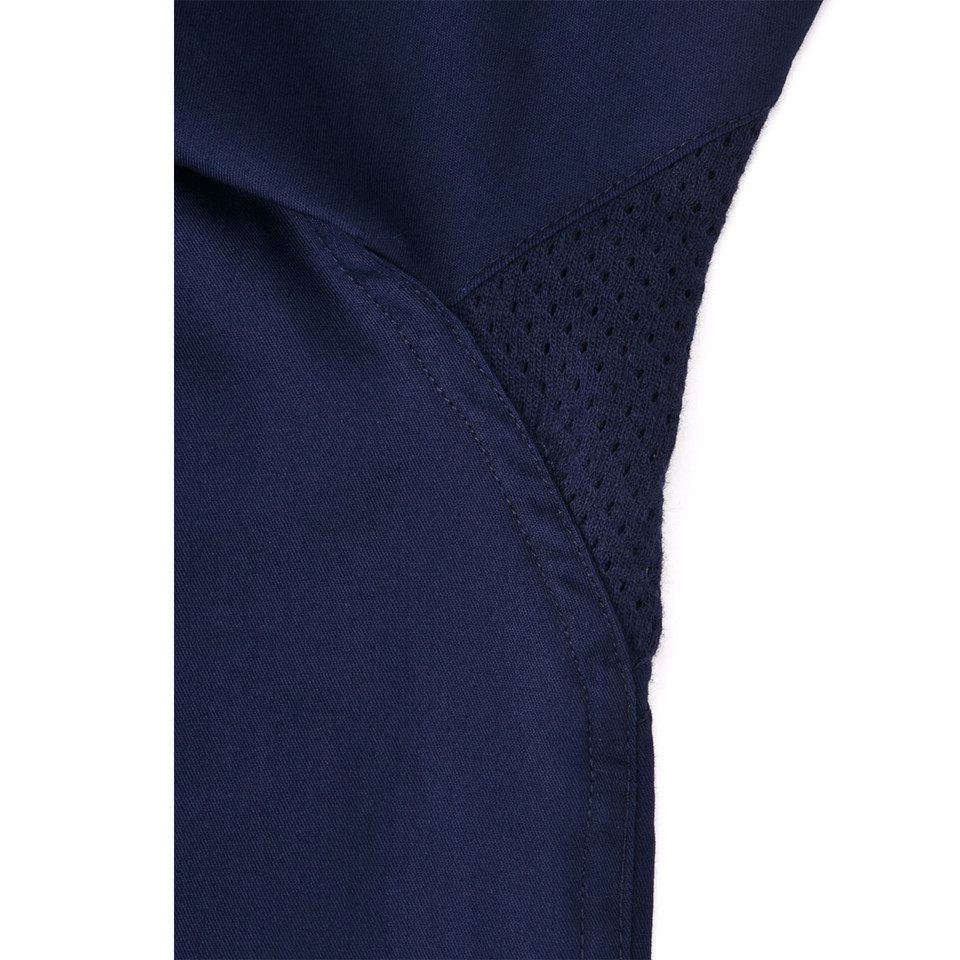 Navy work shirt showing breathable mesh ventilation panels under arm with flatlock stitching detail