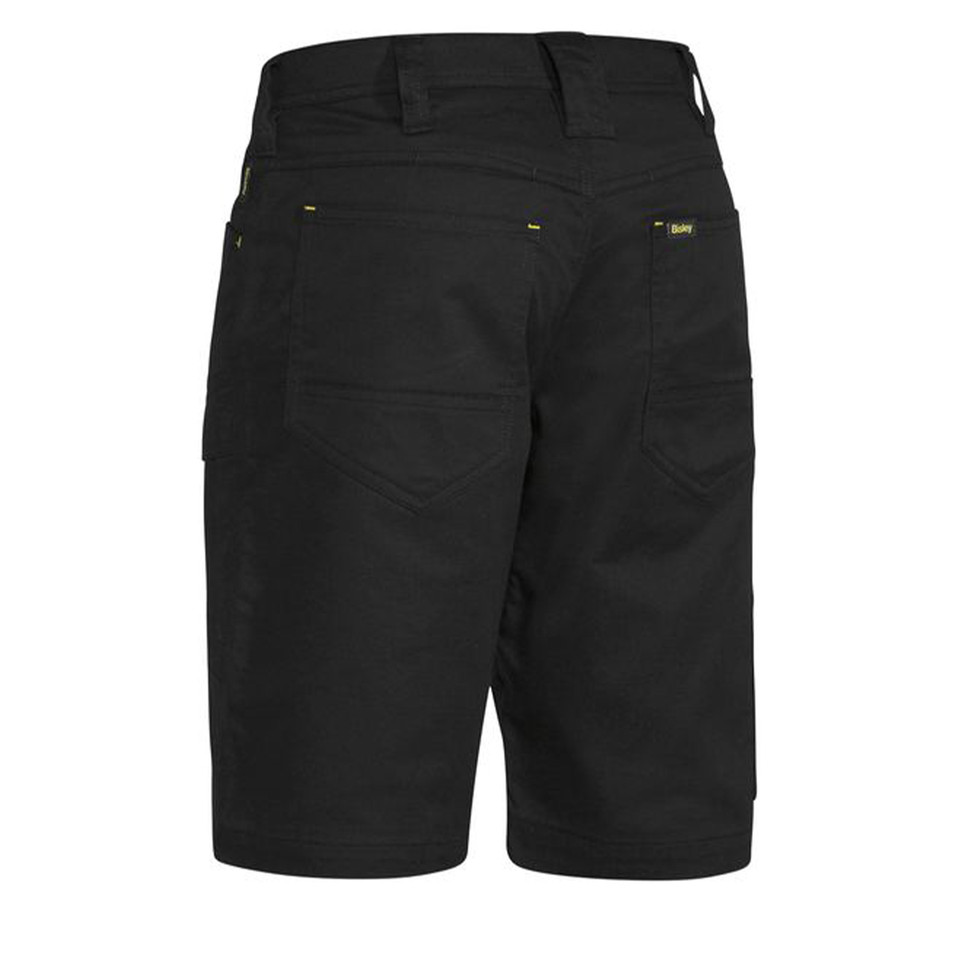 Black men's work shorts rear view showing multi-pocket design, yellow contrast stitching and ripstop fabric texture