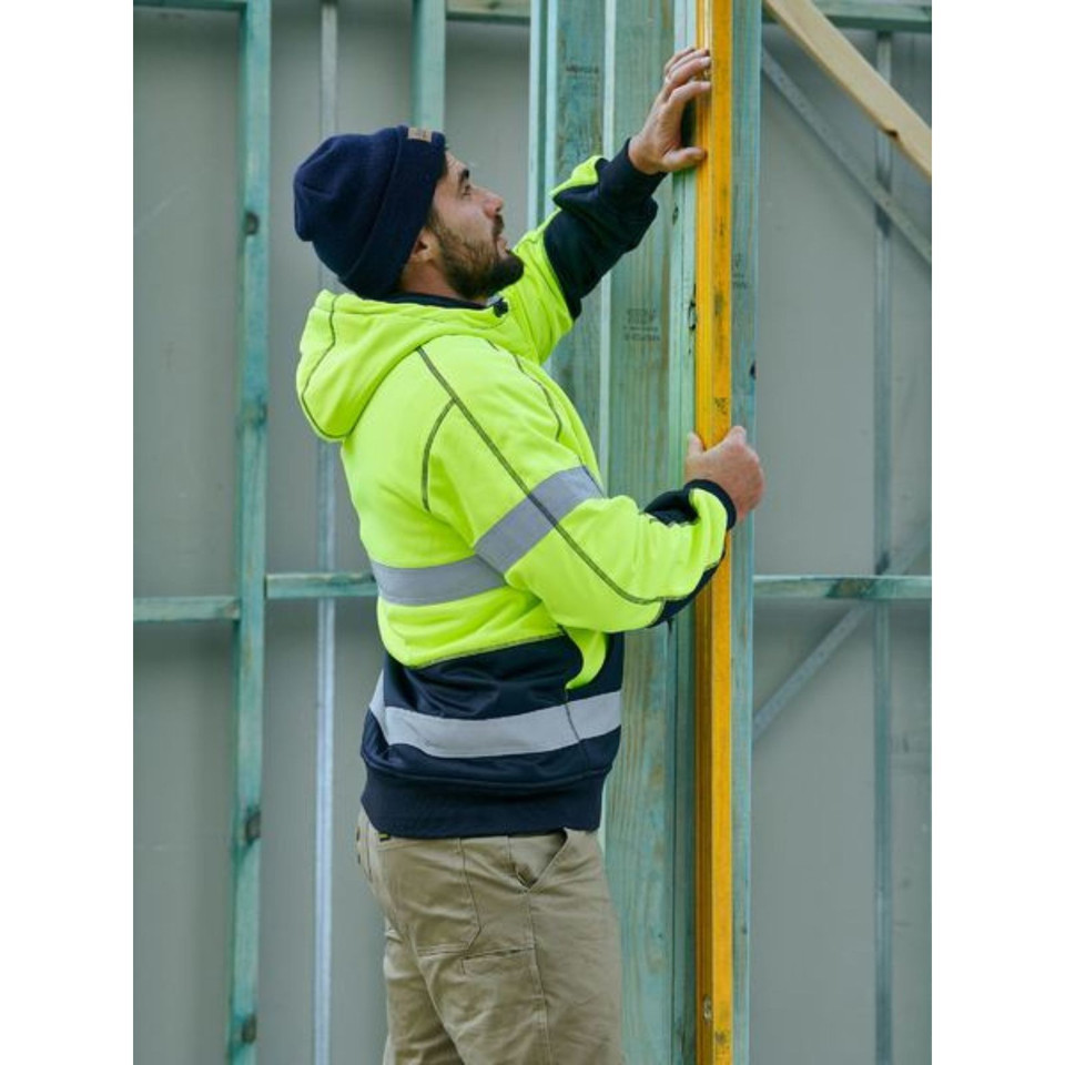 Safety yellow and navy hi vis hoodie with reflective tape shown on worksite, featuring contrast hood lining