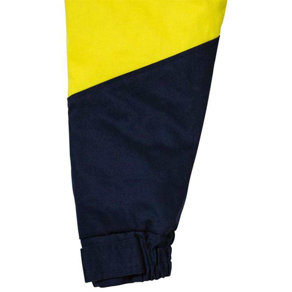 Close-up of hi vis jacket sleeve hem in yellow and navy two-tone drill fabric with adjustable cuff strap