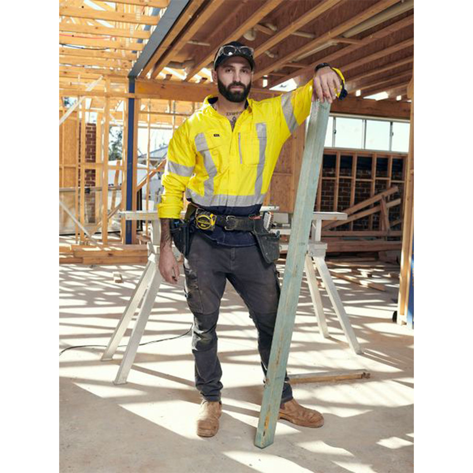 Hi-vis yellow long sleeve shirt with charcoal grey contrast panels and reflective tape on construction worker