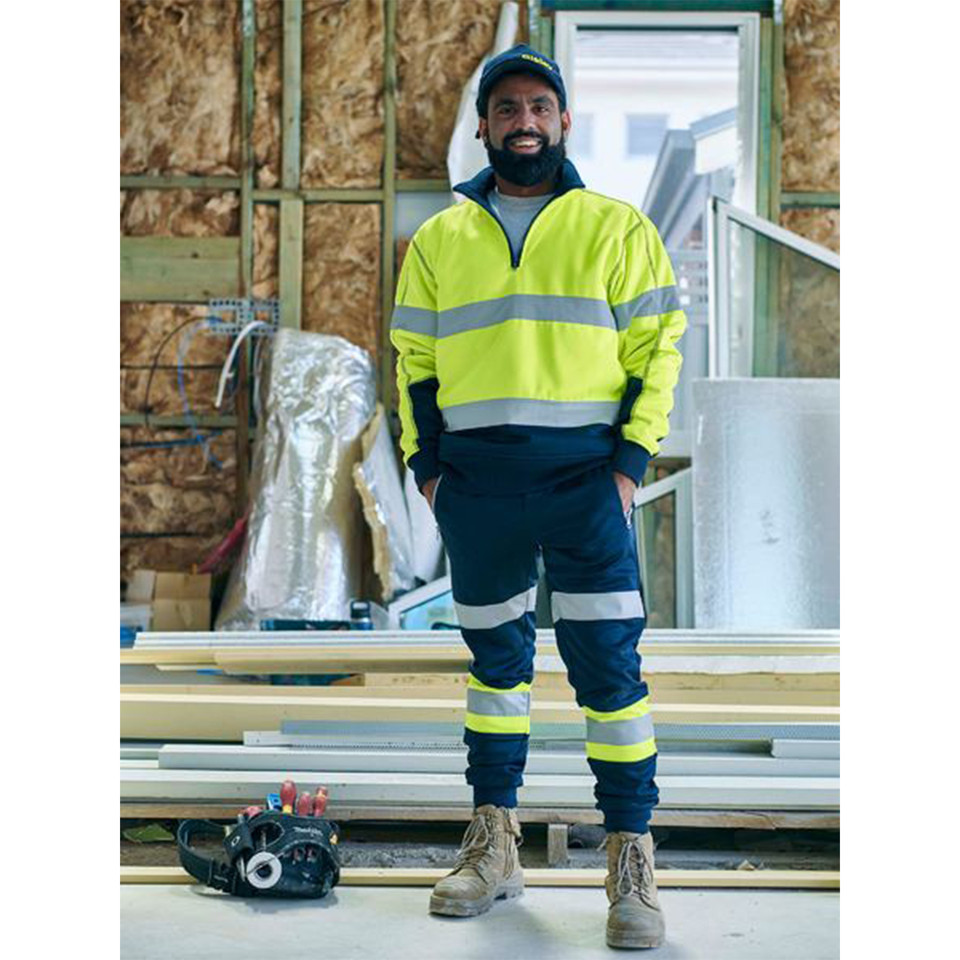 Bisley men's hi-vis taped biomotion track pants, featuring segmented reflective tape and comfortable fleece fabric for high-visibility site safety workwear.