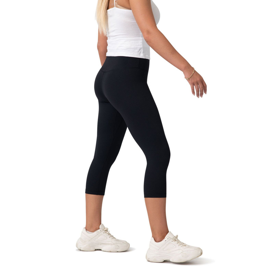 Woman wearing black high-rise capri leggings with wide waistband, cropped above the calf, rear three-quarter view