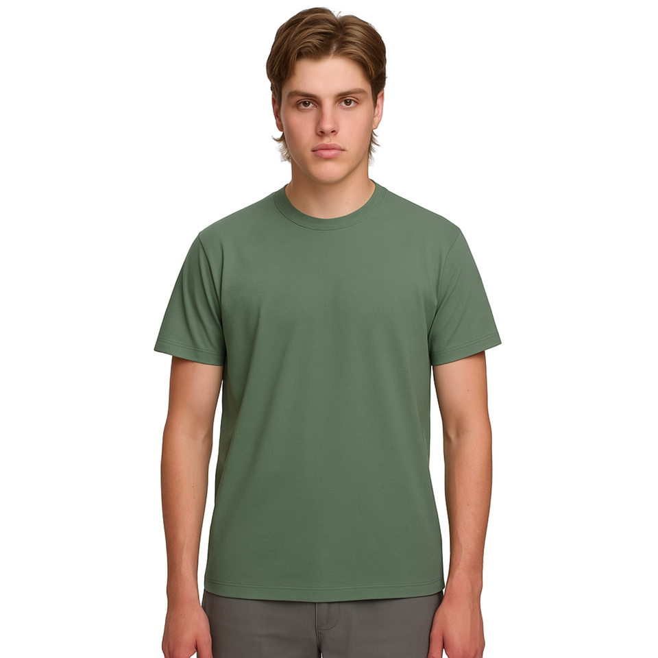 A male model with light brown hair wearing a plain mineral green Soho Men's Premium New Tech Cotton Face T-shirt, standing against a white background.