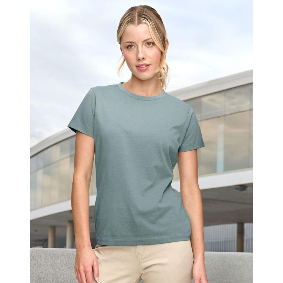 Woman wearing a sage green crew neck short sleeve tee with smooth flat front panel, fitted silhouette
