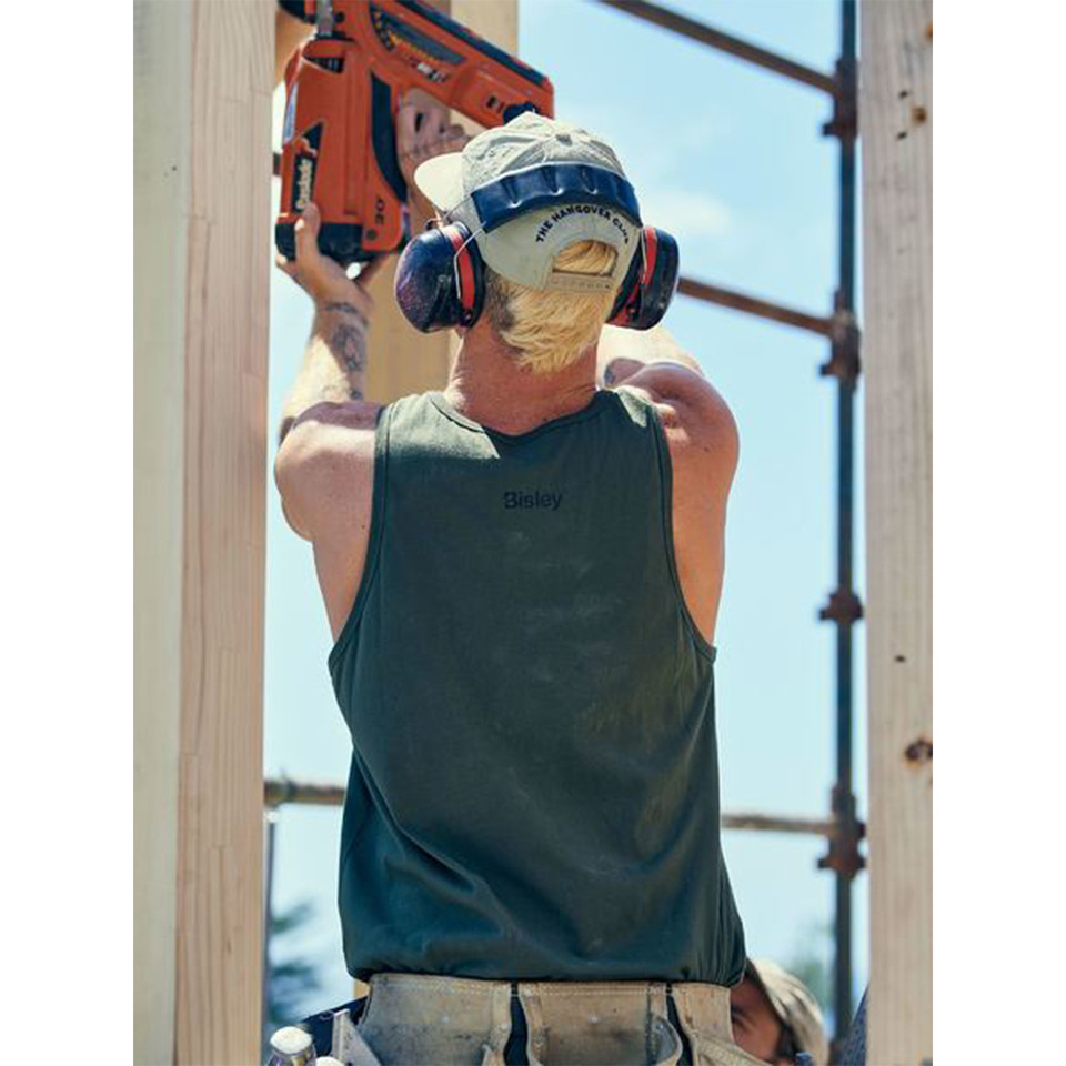 Forest green cotton singlet with small chest logo, worn by person in safety gear at construction site
