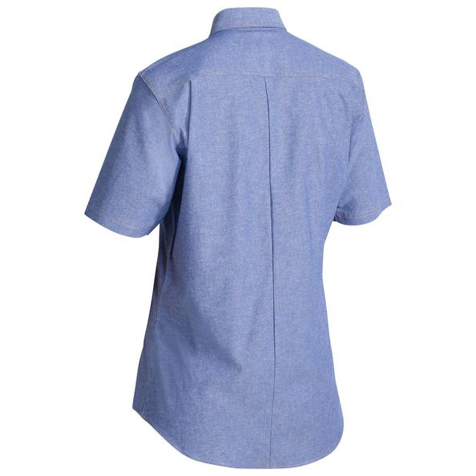 Rear view of womens chambray short sleeve shirt in blue with centre back pleat and curved hem
