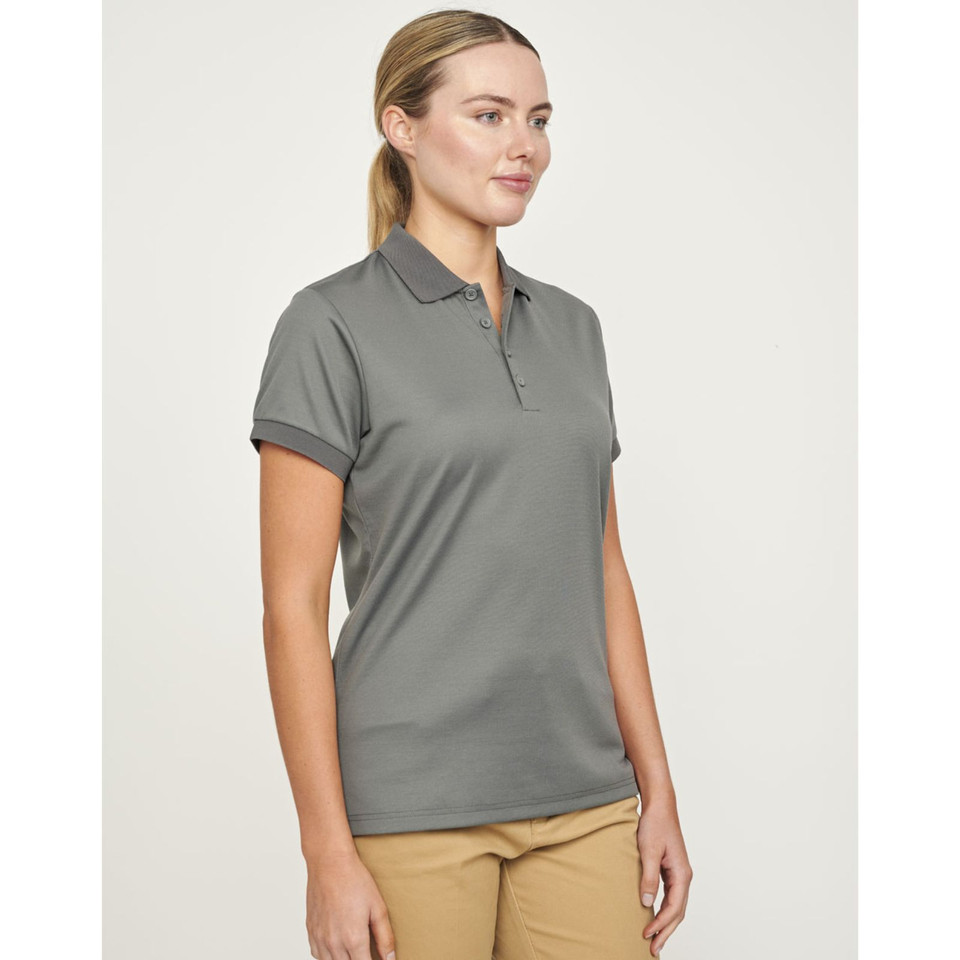 Women's grey recycled PET polo shirt with short sleeves and collar, paired with tan chino pants