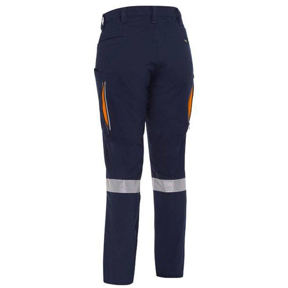 Navy women's cargo pant with orange side vents, reflective tape bands at lower leg, rear view packshot