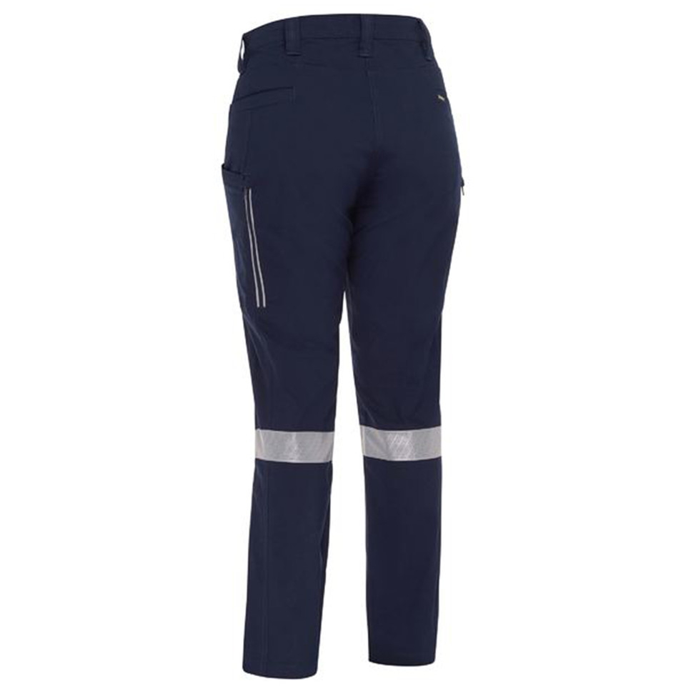 Navy women's stretch cargo pants rear view showing reflective tape bands, zip side pockets, and ripstop fabric texture