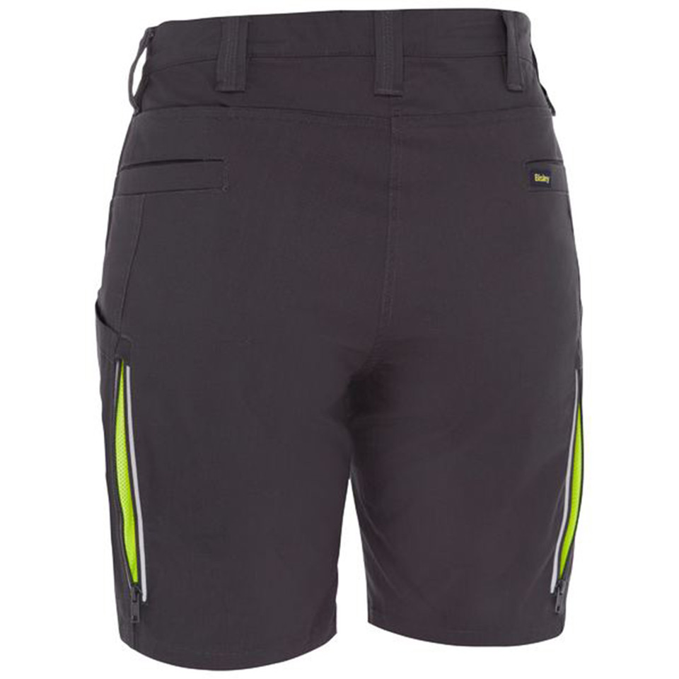 Charcoal women's cargo shorts rear view with lime green zip side vents and reflective trim detailing