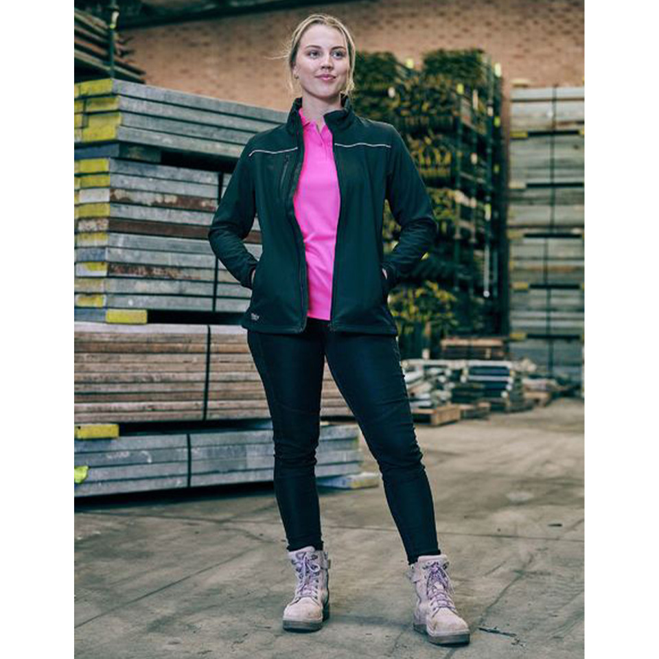 Woman wearing black stretch jeans with cargo pocket detail and forest green jacket over hot pink top