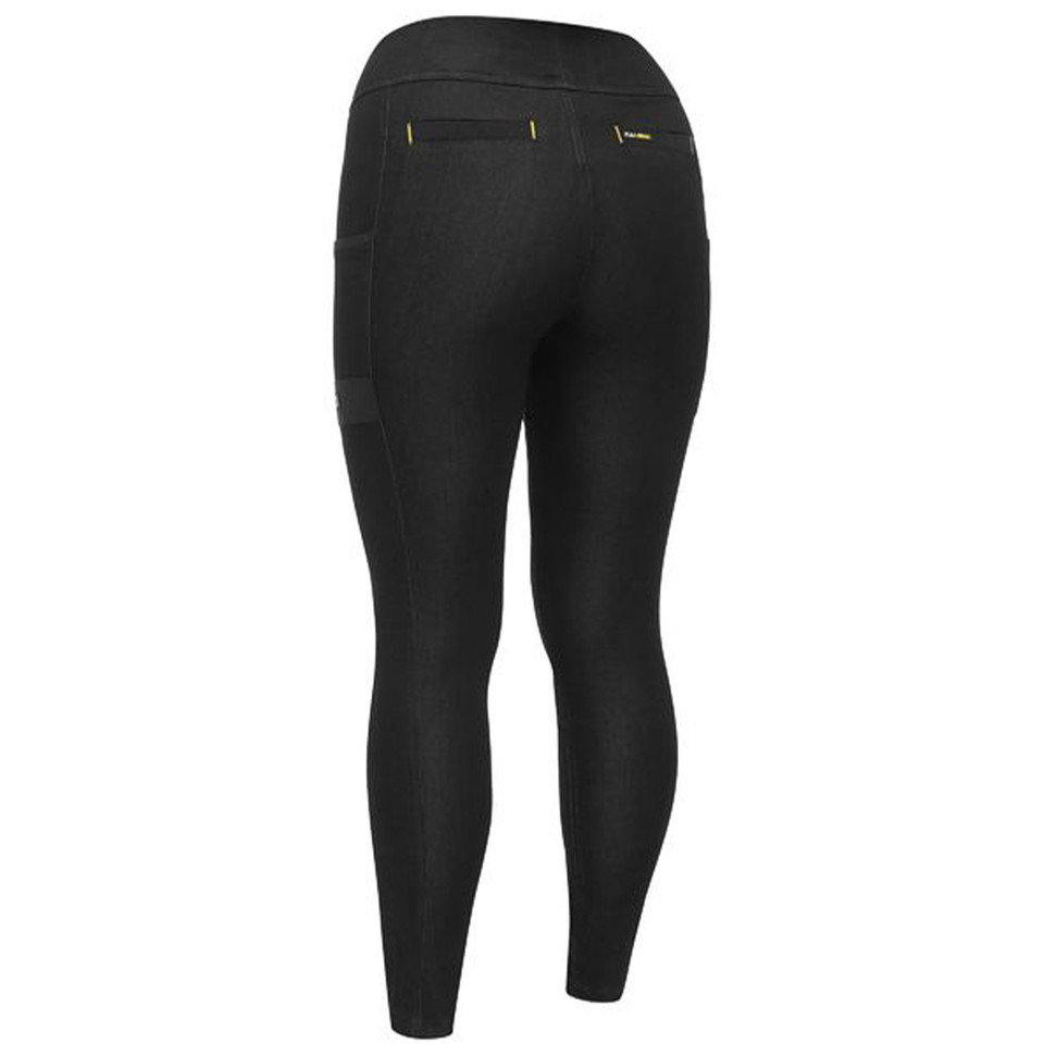Black stretch industrial jeggings with rear patch pockets and gold rivets shown from back