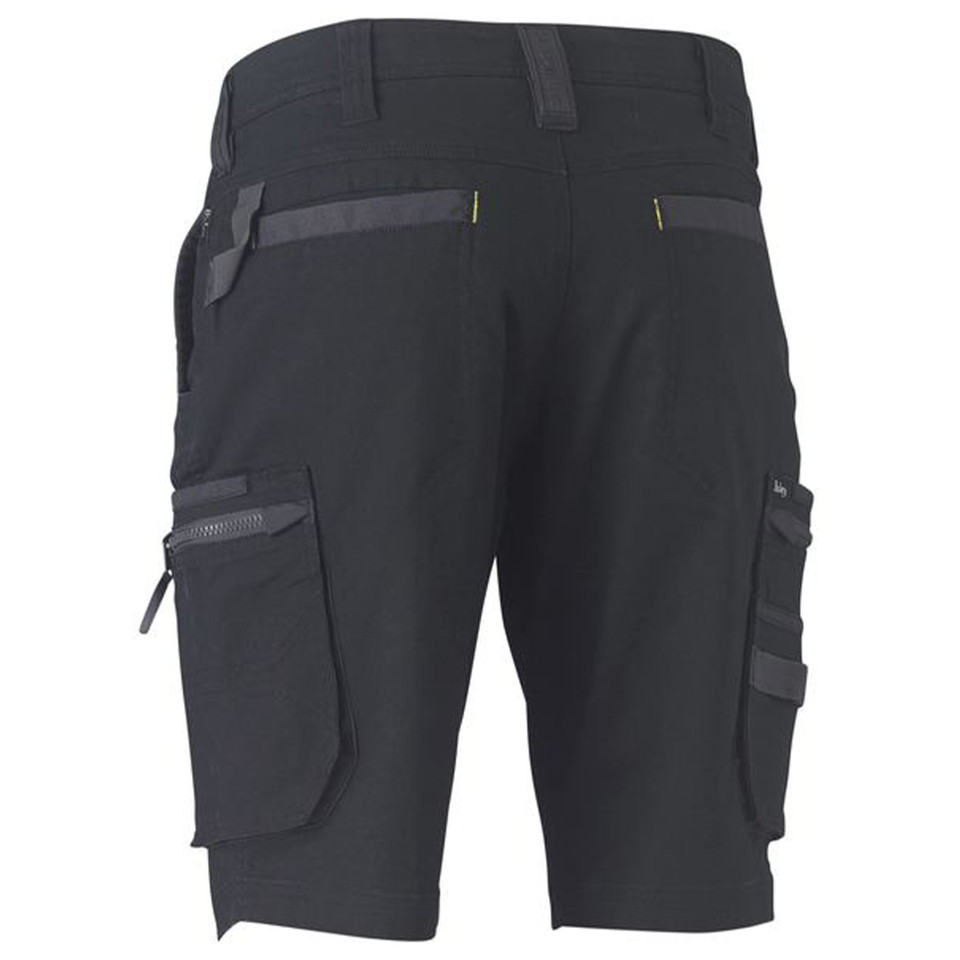 Rear view of charcoal stretch cargo shorts with zip pockets, yellow pull tabs, and contrast panel details