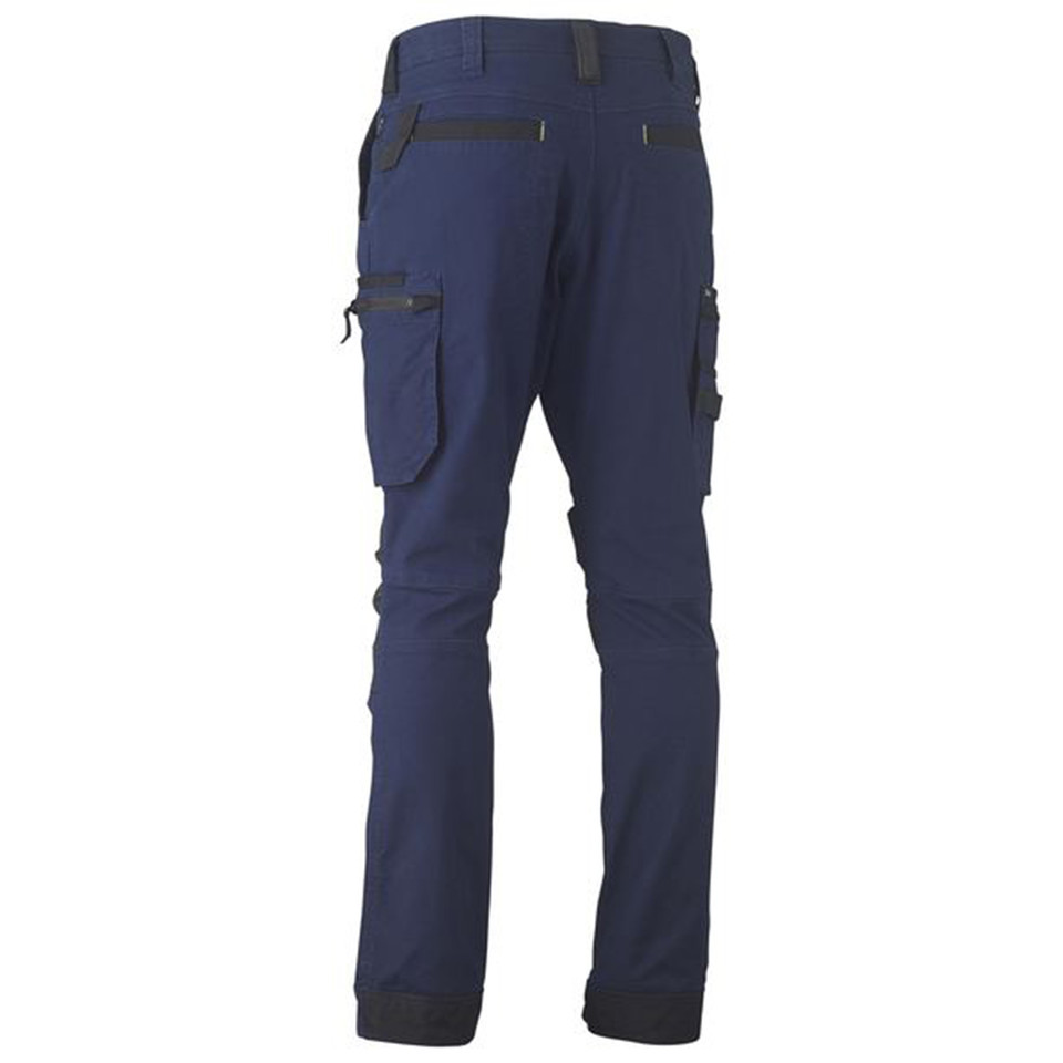 Navy stretch cargo pants rear view, contrast charcoal zip pockets, multi-pocket utility design, tapered leg