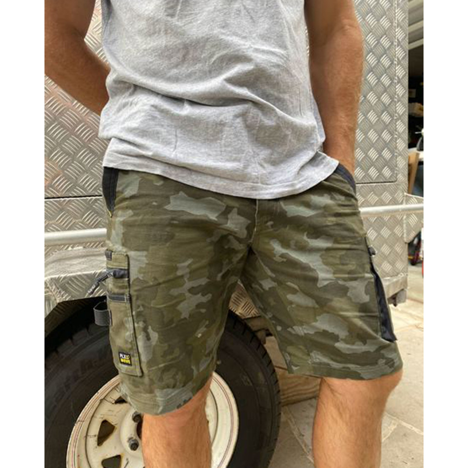 Olive green camouflage cargo shorts with side pockets and stretch canvas fabric worn with grey tee